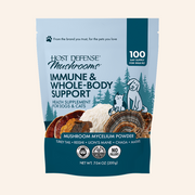 Host Defense Mushrooms Immune & Whole-Body Support supplement pouch for dogs and cats, featuring a light blue and dark teal design with illustrations of a dog, cat, pine trees, and mushroom mycelium.