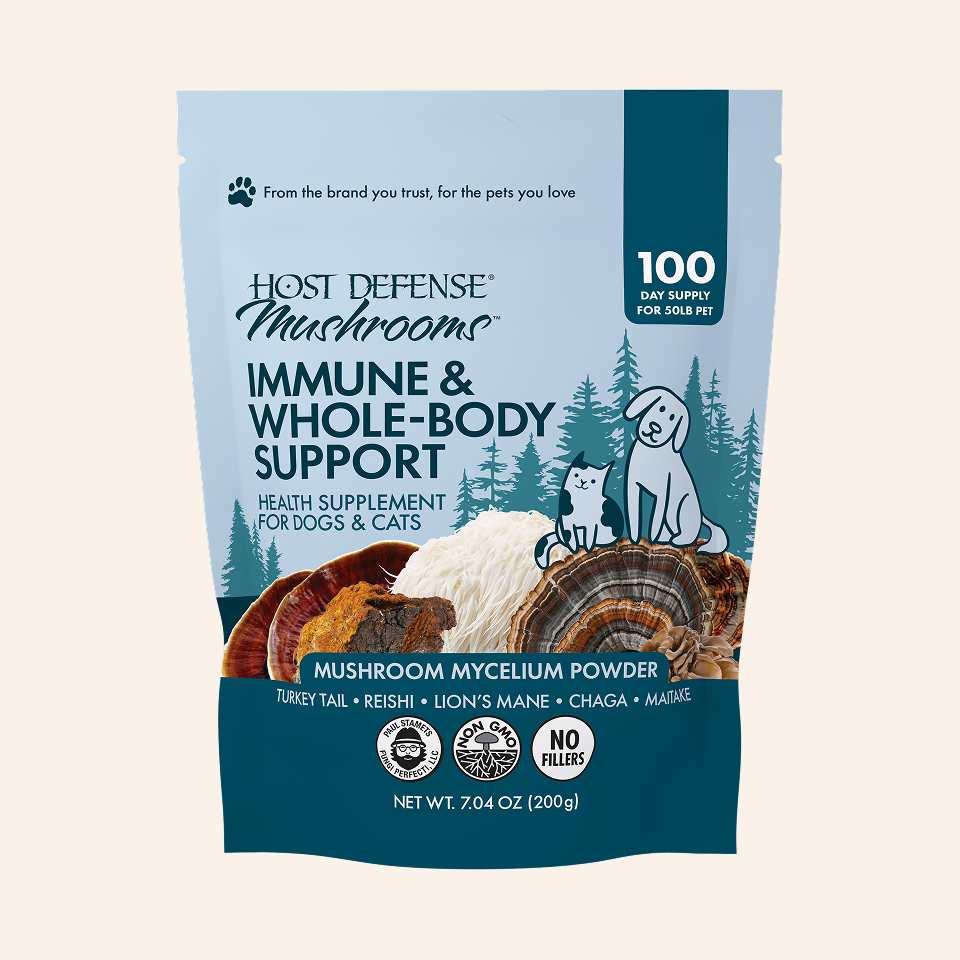 Host Defense Mushrooms Immune & Whole-Body Support supplement pouch for dogs and cats, featuring a light blue and dark teal design with illustrations of a dog, cat, pine trees, and mushroom mycelium.